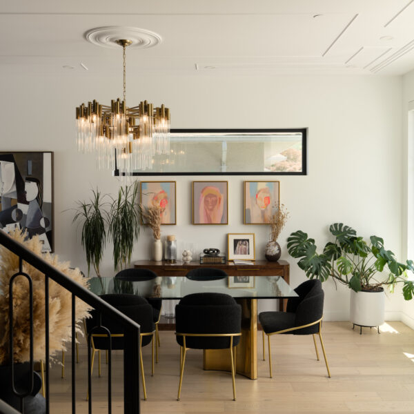 Bright dining room with brass chandelier, gallery wall art, and view of staircase at 2305 W King Edward